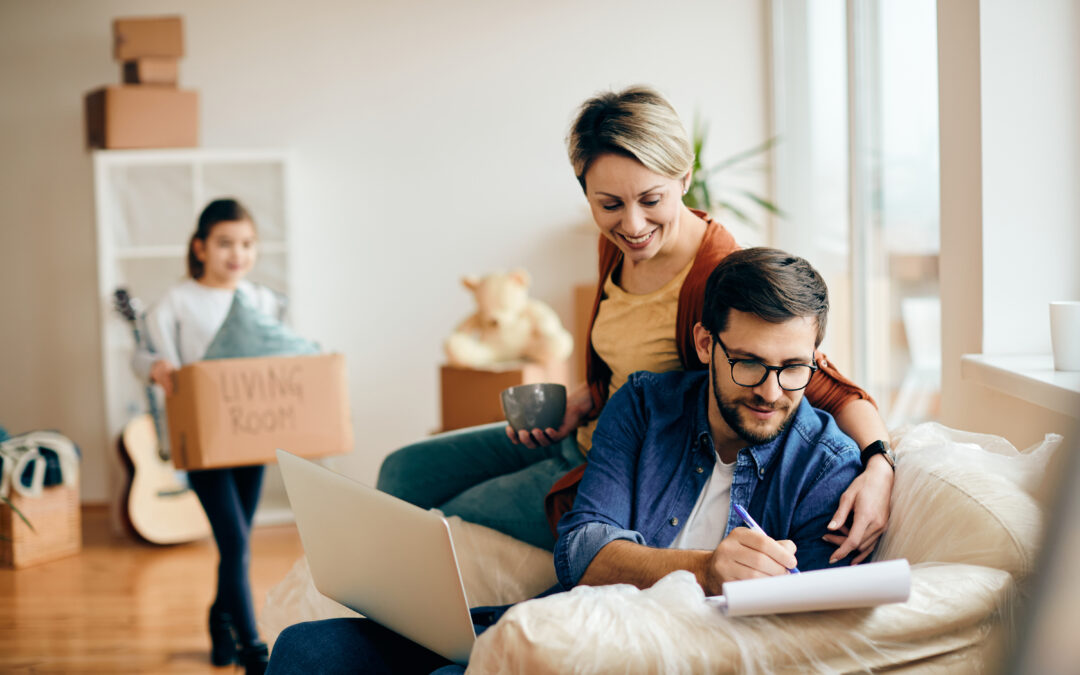 Happy parents with daughter relocating into a new apartment.